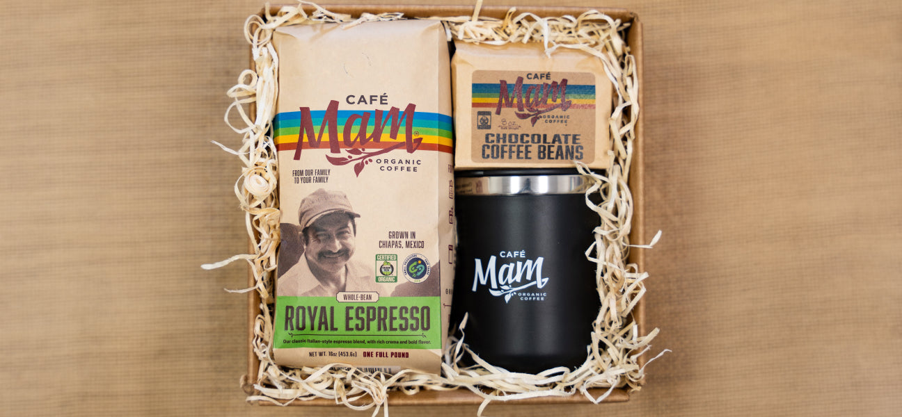 Café Mam coffee package and tumbler in a gift box on a wooden surface