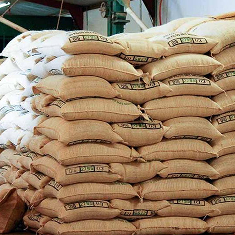 Stack of brown bags with visible labels in an indoor setting