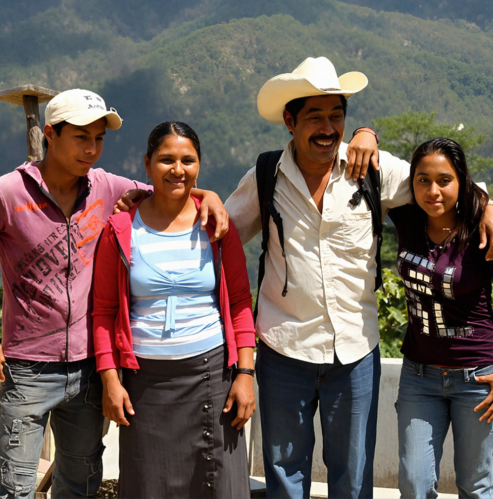 Four people posing together with a mountainous background