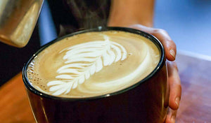 Cappuccino art. Organic espresso beans. Swiss Water Process decaffeinated espresso beans.
